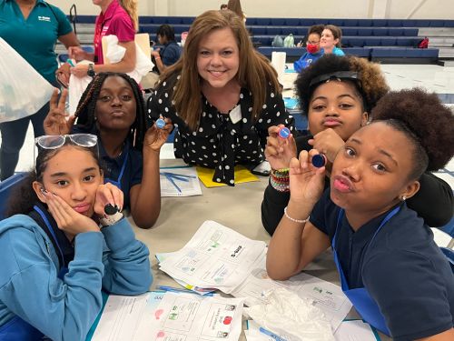 Female Mentor posing with 4 students