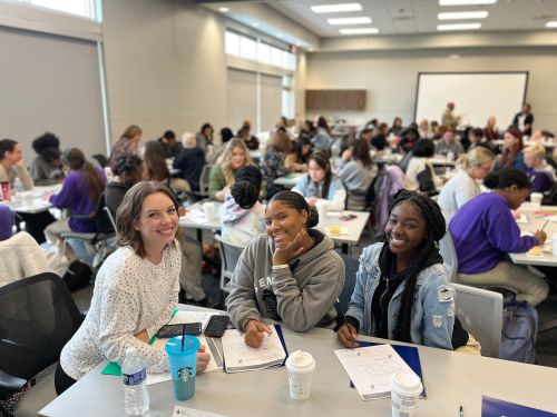 Female Mentor posing with 2 students