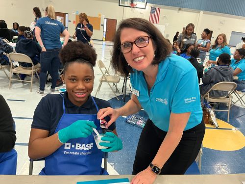 Female Mentor posing with 1 student for experiment