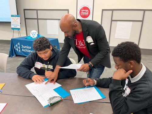 Male mentor interacting with 2 male students